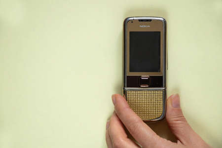 Ukraine Dnipro 10/23/2020 - Nokia 8800 gold lies on an isolated background, an old rarity phoneのeditorial素材