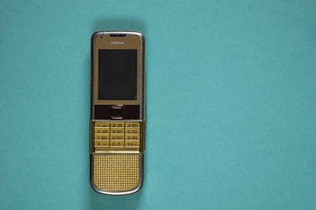 Ukraine Dnipro 10/23/2020 - Nokia 8800 gold lies on an isolated background, an old rarity phoneのeditorial素材