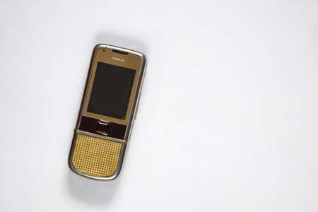 Ukraine Dnipro 10/23/2020 - Nokia 8800 gold lies on an isolated background, an old rarity phoneのeditorial素材