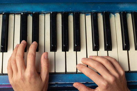 female hands on the piano close up, musical instrumentの写真素材