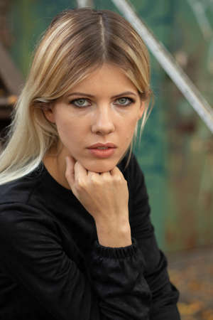 portrait of a young Ukrainian girl on the street in a black dress, portrait of a model