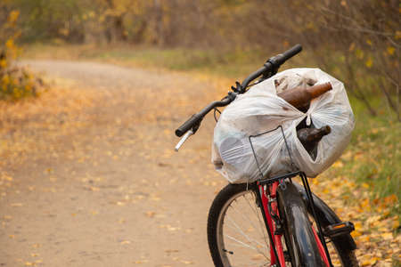 garbage bag on a bicycle in the forest in autumn, garbage collection in the forest in Ukraineの写真素材