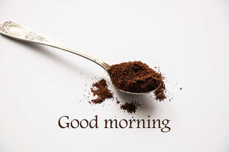 spoon of ground roasted coffee on isolated white backgroundの写真素材