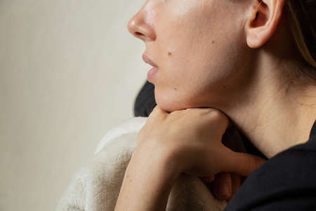 portrait of a young girl with long hair on a white background, sad girl lonelyの写真素材
