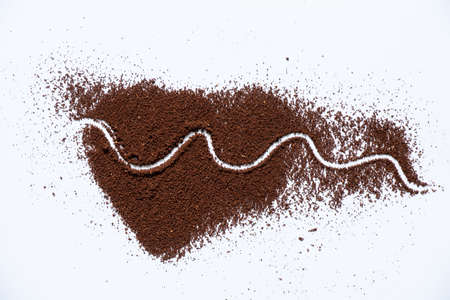 ground roasted coffee sprinkled on white background close upの写真素材
