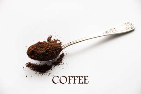 spoon of ground roasted coffee on isolated white backgroundの写真素材