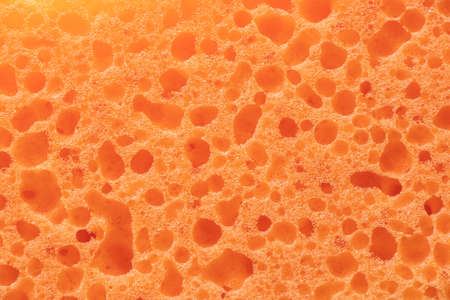 orange bathing sponge as background close-upの写真素材