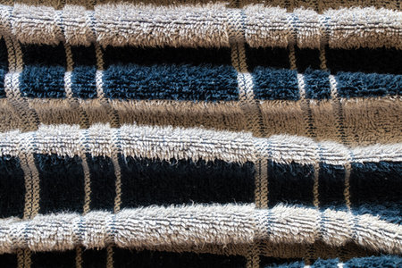 men's striped towel in white and black stripes for a shower as a background close-upの写真素材