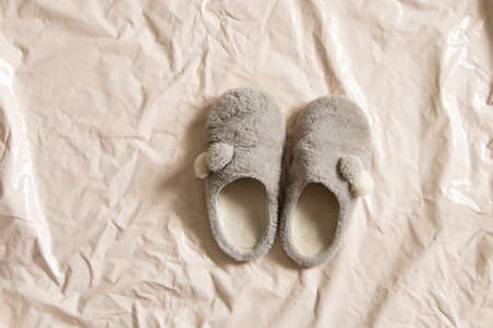 gray indoor soft warm shoes stands on a beige background close-upの写真素材