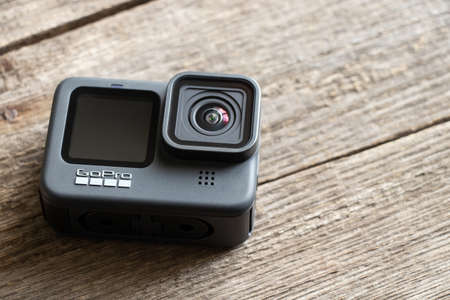 Ukraine Dnepr 01/06/2021 - Camera Go pro 9 lies on a wooden table, a review of the new action cameraのeditorial素材