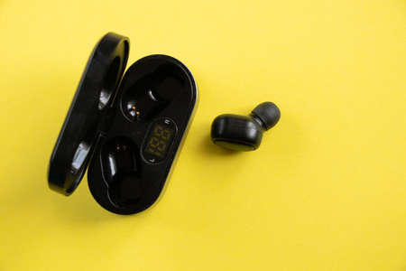wireless headphones on isolated colored background close-upの写真素材