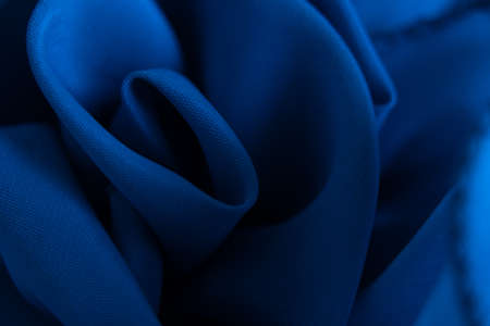 blue silk wrinkled fabric in waves as background for designの写真素材