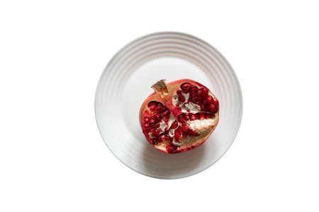 cut pomegranate on a white background close upの写真素材