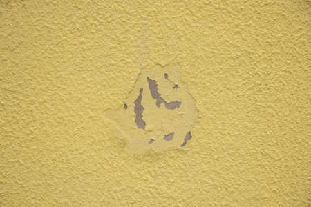 yellow rough wall of a house as background close upの写真素材
