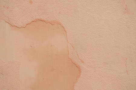peach colored house wall as background close upの写真素材