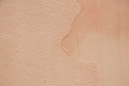 peach colored house wall as background close upの写真素材