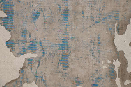 peeling putty on the wall of the house as a background close-upの写真素材