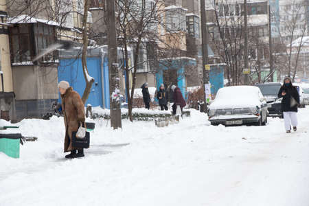 Ukraine Dnipro 01.13.2021 - snow fell in a residential area of the city of Dnipro, city dwellers on the streets of a residential yardのeditorial素材