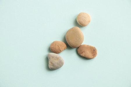 sea smooth small pebble stones lie on a colored background close-upの写真素材