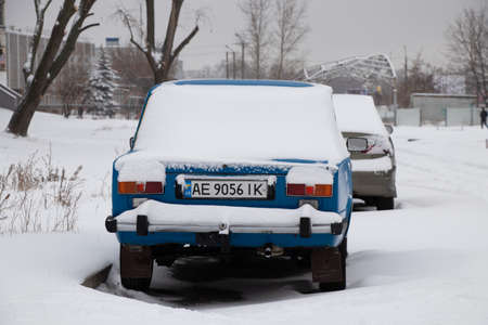 Ukraine Dnipro 14.01.2021 - old Soviet Zhiguli stand near a house in the snowのeditorial素材
