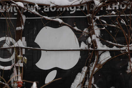 Ukraine Dnipro 01.13.2021 - Apple sign is drawn on a black banner in the form of a fence for a flower bedのeditorial素材