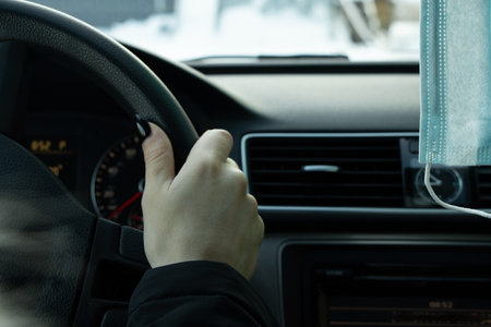 medical mask on the rear-view mirror in a passenger car during a pandemic, health careの写真素材