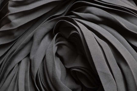 black wavy flowing fabric as background close-upの写真素材