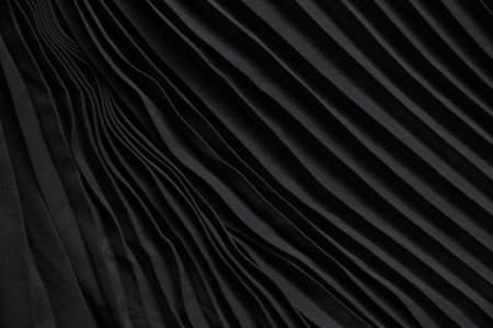 black wavy flowing fabric as background close-up