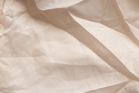 light beige wrinkled polyester fabric as background close-upの写真素材