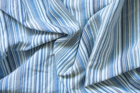 striped fabric in blue and white stripes as background close upの写真素材