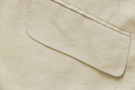 pocket of men's beige jacket close up as backgroundの写真素材