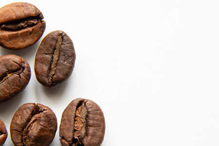 roasted whole grains of coffee on white background macro photoの写真素材