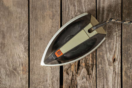 old soviet black iron lies on a wooden tableの写真素材