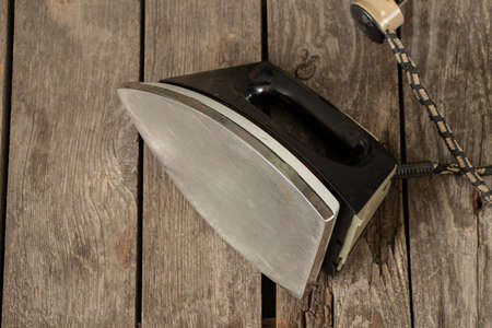 old soviet black iron lies on a wooden tableの写真素材