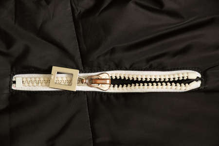 white zipper on a black background close-up, zipper on a jacket close-upの写真素材