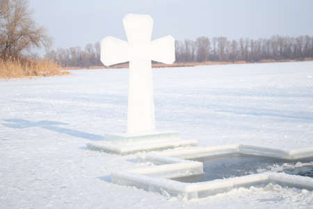 an ice cross on the Dnieper on the ice near ice holes for diving on the day of the Epiphany in Ukraine in the city of Dniproの写真素材