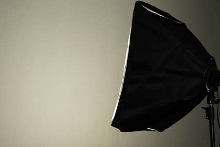 constant studio light with softbox shines on the wall, studio light in studioの写真素材