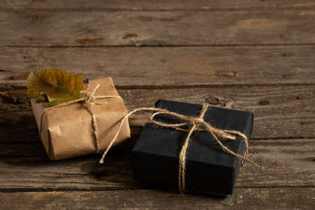 Christmas gift boxes made of paper thread and handmade Christmas decor on a wooden background, gift boxの写真素材