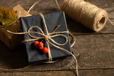 Christmas gift boxes made of paper thread and handmade Christmas decor on a wooden background, gift boxの写真素材