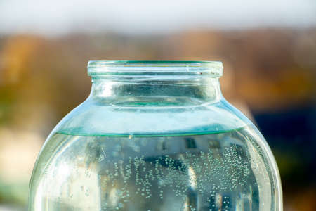 transparent glass jar with water close up