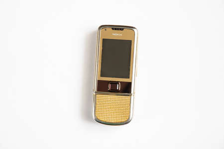 Ukraine Dnipro 10/23/2020 - Nokia 8800 gold lies on an isolated background, an old rarity phoneのeditorial素材