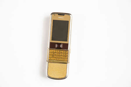 Ukraine Dnipro 10/23/2020 - Nokia 8800 gold lies on an isolated background, an old rarity phoneのeditorial素材