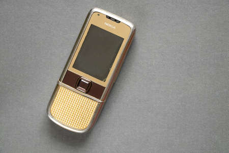 Ukraine Dnipro 10/23/2020 - Nokia 8800 gold lies on an isolated background, an old rarity phoneのeditorial素材