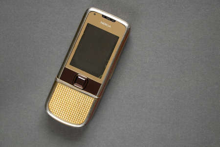 Ukraine Dnipro 10/23/2020 - Nokia 8800 gold lies on an isolated background, an old rarity phoneのeditorial素材