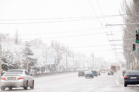 Ukraine Dnipro 08.03.2021 - winter road with cars in a sleeping district along the embankment in the morning, people go to the robot in the morningのeditorial素材
