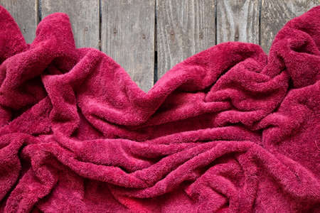 red crumpled towel as background close-upの写真素材