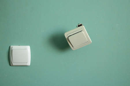 two switches on one wall drywall one of them is broken, renovation in the apartmentの写真素材