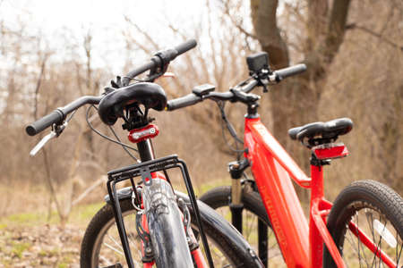 Ukraine Dnepr 06.04.2021 - a new red electric bike in the park in the spring in the sun, a bike rideのeditorial素材
