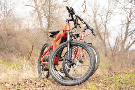Ukraine Dnepr 06.04.2021 - a new red electric bike in the park in the spring in the sun, a bike rideのeditorial素材