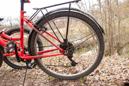 Ukraine Dnepr 06.04.2021 - a new red electric bike in the park in the spring in the sun, a bike rideのeditorial素材